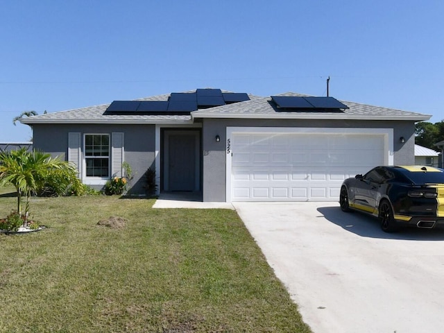 single story home with a garage, a front yard, and solar panels