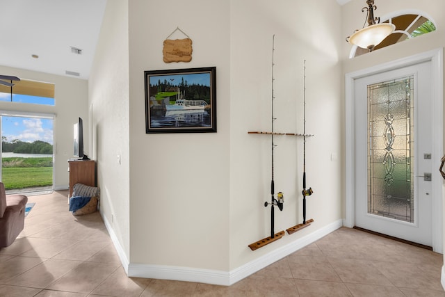 tiled entrance foyer with high vaulted ceiling