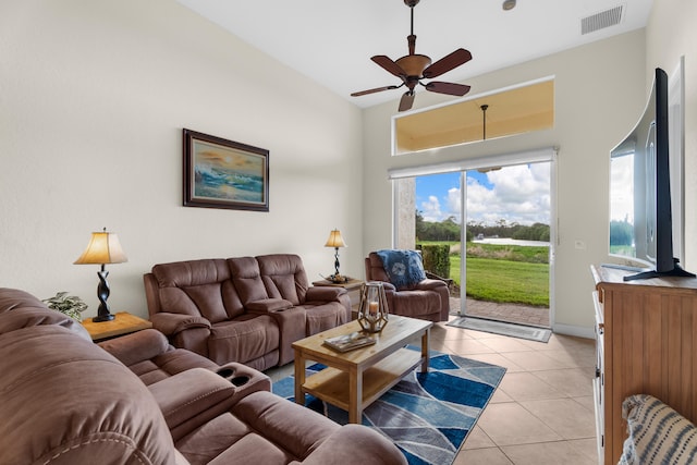 tiled living room featuring high vaulted ceiling and ceiling fan