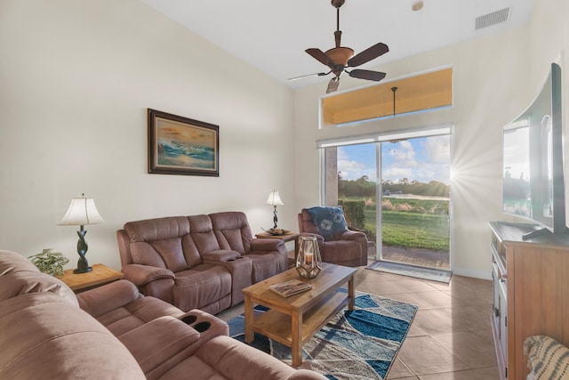 tiled living room featuring high vaulted ceiling and ceiling fan