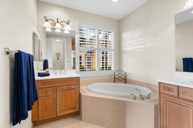 bathroom with vanity, tile patterned flooring, and tiled tub