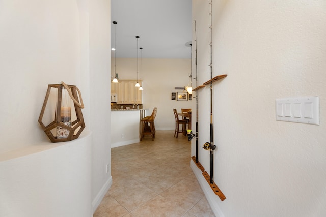 hall featuring light tile patterned floors