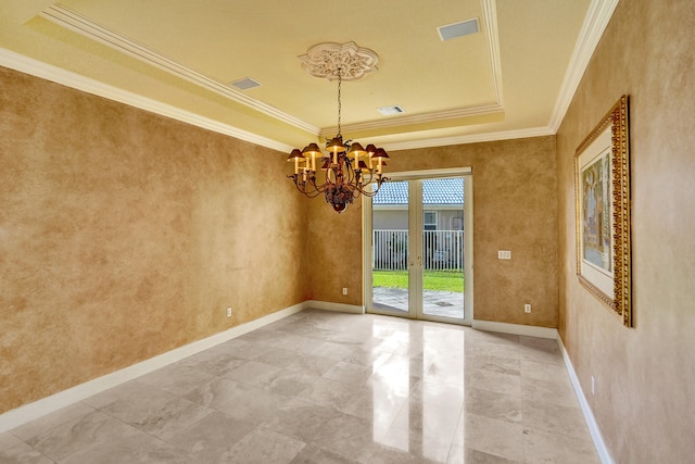 spare room with a raised ceiling, french doors, a notable chandelier, and crown molding