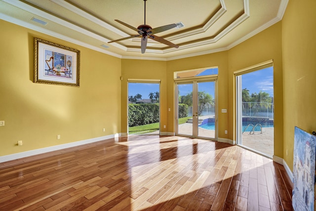 interior space featuring light wood-type flooring, a wealth of natural light, ceiling fan, and crown molding