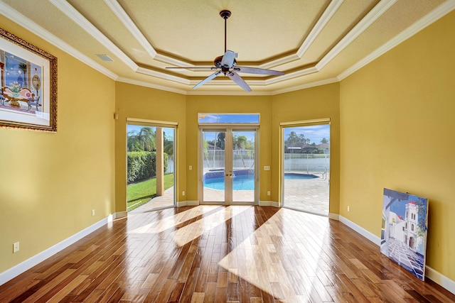 doorway featuring french doors, hardwood / wood-style flooring, ceiling fan, and crown molding