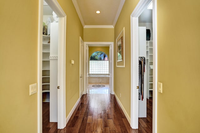 hall with dark hardwood / wood-style floors and ornamental molding