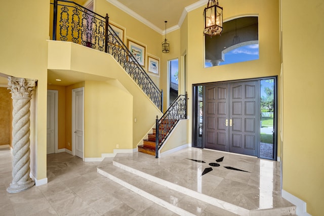 foyer featuring a high ceiling and crown molding