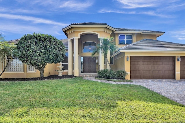 view of front of property featuring a garage and a front lawn