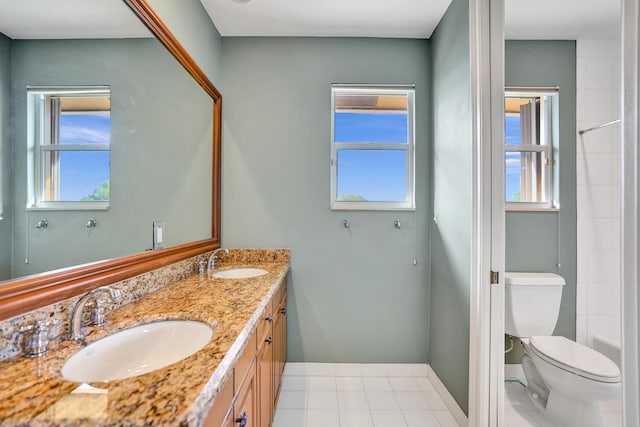 bathroom with a wealth of natural light, vanity, and toilet