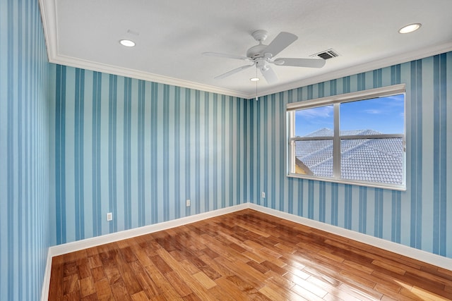 spare room with wood-type flooring, ceiling fan, and crown molding