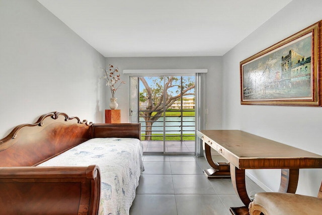 bedroom with access to exterior, tile patterned floors, and a water view