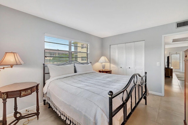 bedroom with a closet and light tile patterned floors