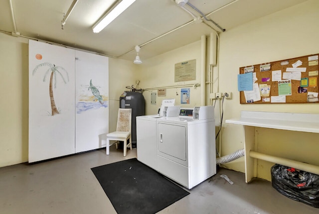 laundry room featuring water heater and independent washer and dryer