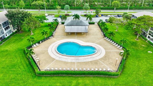 view of pool with a lawn and a patio area