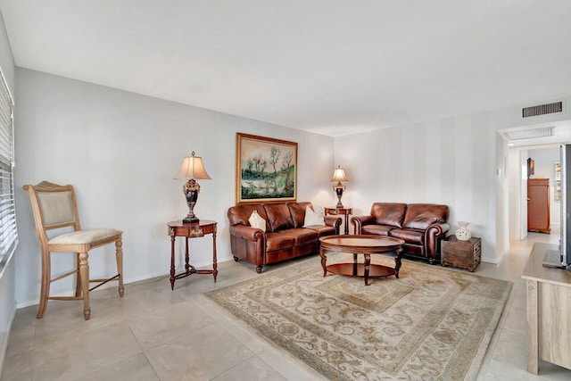 living room with a wealth of natural light and light tile patterned floors