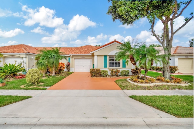 view of front of property featuring a garage, concrete driveway, stucco siding, and a tile roof