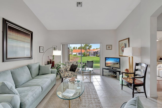 living room with light tile patterned floors and lofted ceiling