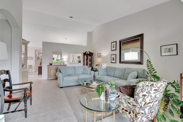 living room featuring light tile patterned floors and vaulted ceiling