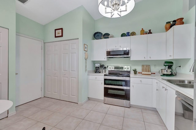 kitchen featuring white cabinetry, stainless steel appliances, high vaulted ceiling, pendant lighting, and light tile patterned floors