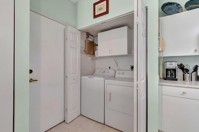 laundry area featuring separate washer and dryer and light tile patterned flooring