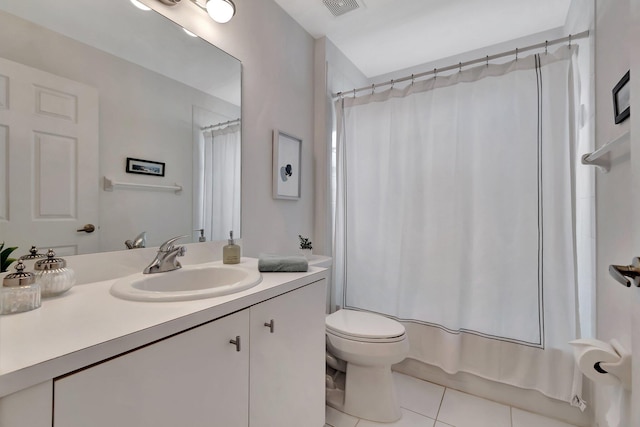 full bathroom featuring tile patterned flooring, vanity, shower / tub combo with curtain, and toilet