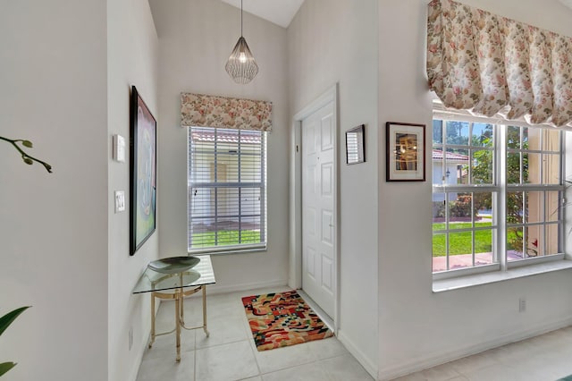 tiled entrance foyer featuring a healthy amount of sunlight