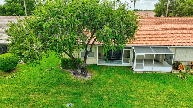 exterior space with a yard and glass enclosure