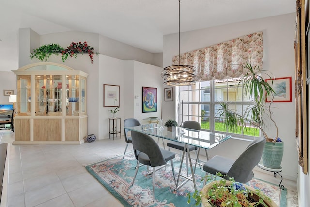 tiled dining area with vaulted ceiling and a notable chandelier