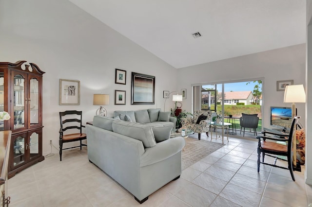 living room featuring light tile patterned floors and high vaulted ceiling