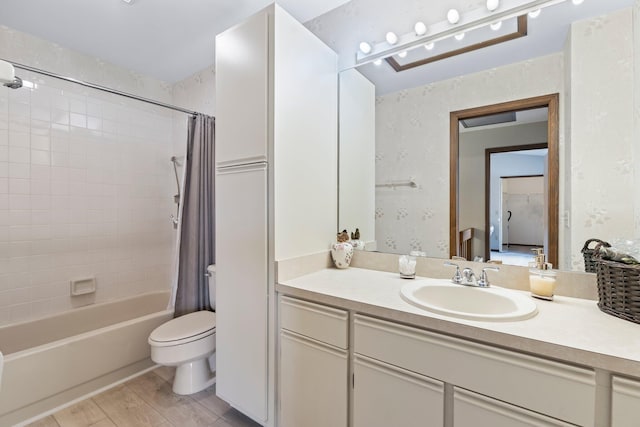 full bathroom featuring hardwood / wood-style flooring, shower / tub combo with curtain, vanity, and toilet