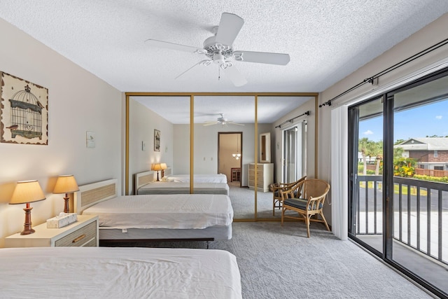 carpeted bedroom featuring a textured ceiling, access to outside, ceiling fan, and a closet