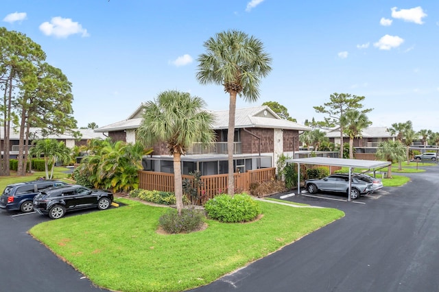 view of front of home featuring a front yard and a carport