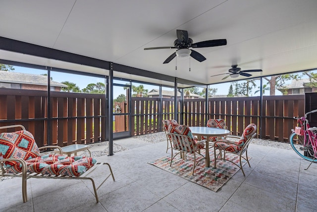 sunroom featuring ceiling fan