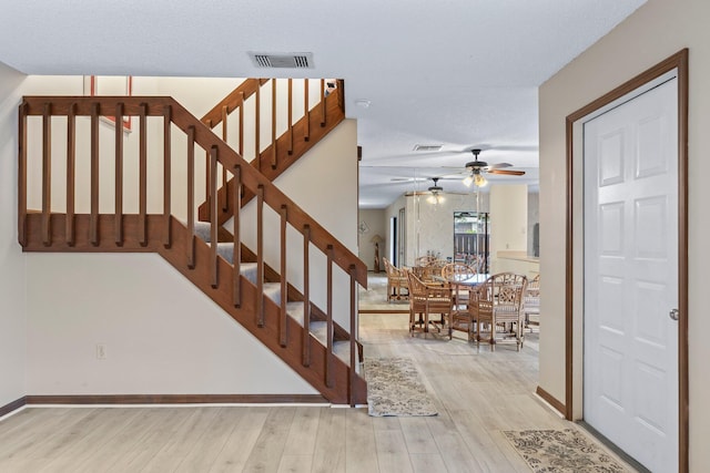 1904 SE Sir Lancelot Dr Unit 0, Port Saint Lucie, FL 34952 - stairway featuring wood finished floors, a ceiling fan, and baseboards