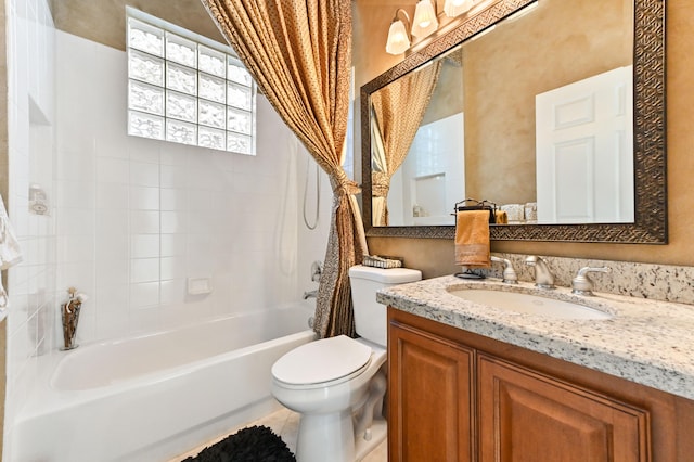 full bathroom featuring tile patterned floors, tiled shower / bath combo, toilet, and vanity