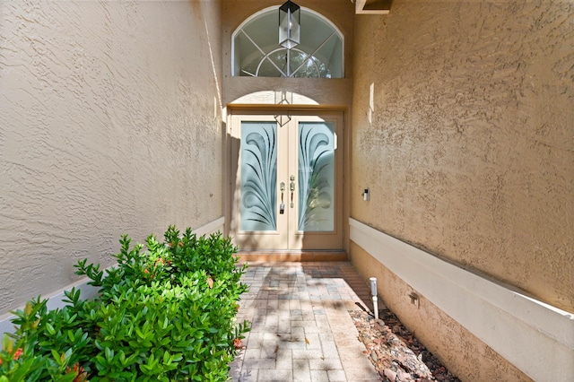 view of exterior entry featuring french doors