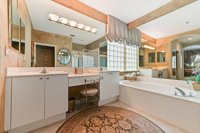 bathroom with tile patterned floors, vanity, and shower with separate bathtub