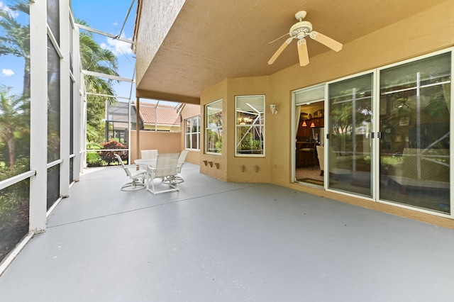 unfurnished sunroom with ceiling fan and a healthy amount of sunlight