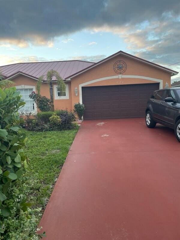 single story home featuring a garage