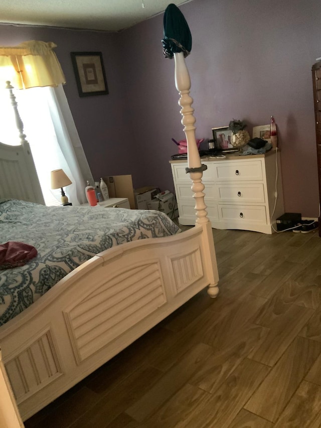 bedroom with dark hardwood / wood-style flooring