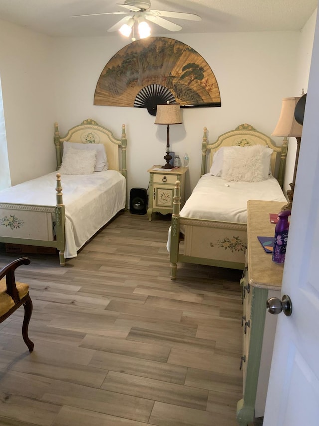 bedroom with ceiling fan and hardwood / wood-style floors