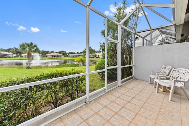 unfurnished sunroom featuring a water view