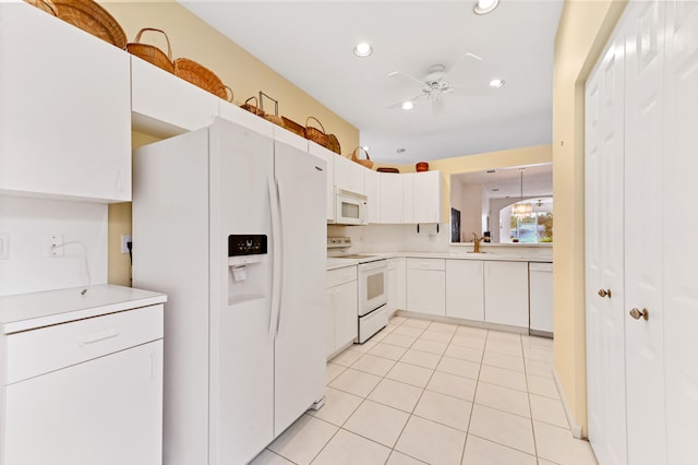 kitchen featuring light tile patterned floors, white appliances, white cabinetry, and ceiling fan