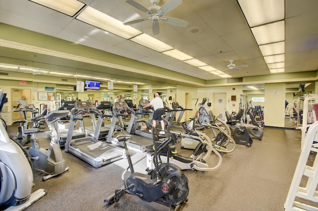 gym with ceiling fan and a drop ceiling