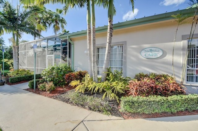 view of side of property with a lanai