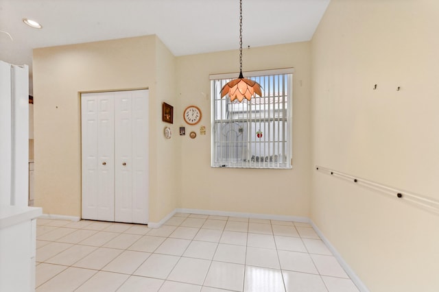 unfurnished dining area featuring light tile patterned floors