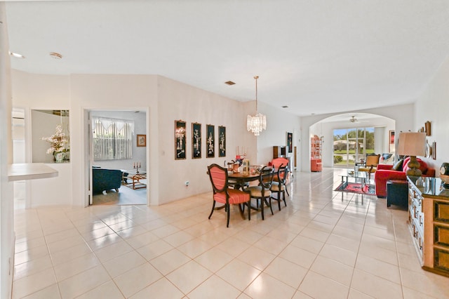 tiled dining area with a notable chandelier