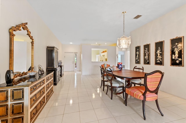 dining area featuring light tile patterned floors and a chandelier