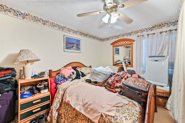 carpeted bedroom featuring ceiling fan and a textured ceiling