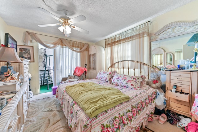 carpeted bedroom featuring ceiling fan and a textured ceiling